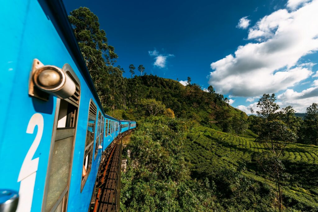 Train from Nuwara Eliya to Kandy among tea plantations in the highlands of Sri Lanka